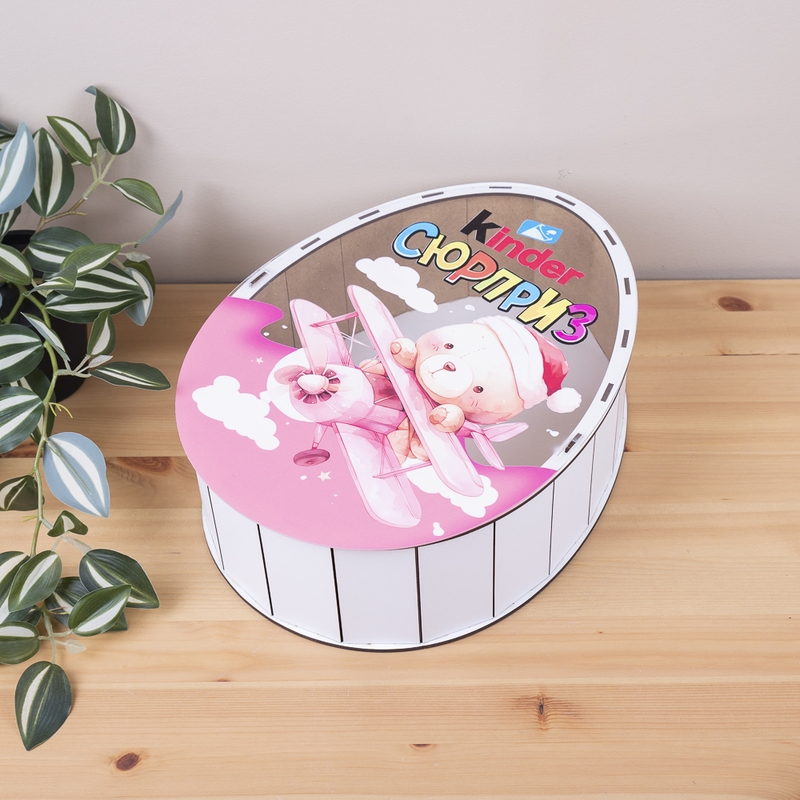 Овальна подарункова коробка Kinder біла з прозорою кришкою 25×19×7 см «Ведмедик в літачку»